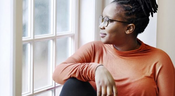 Woman-calmly-looks-out-window